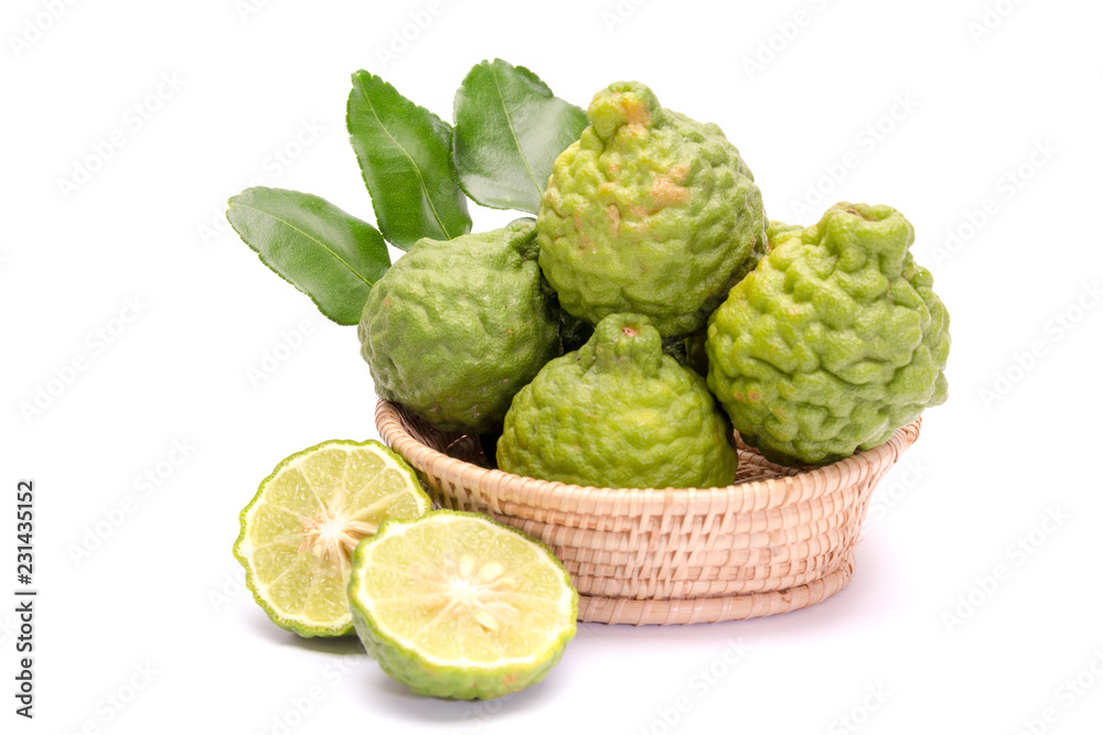 The kaffir lime leaves in the basket on a white background.