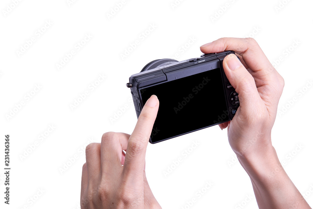 Mirrorless photo camera  in hand isolated on white background