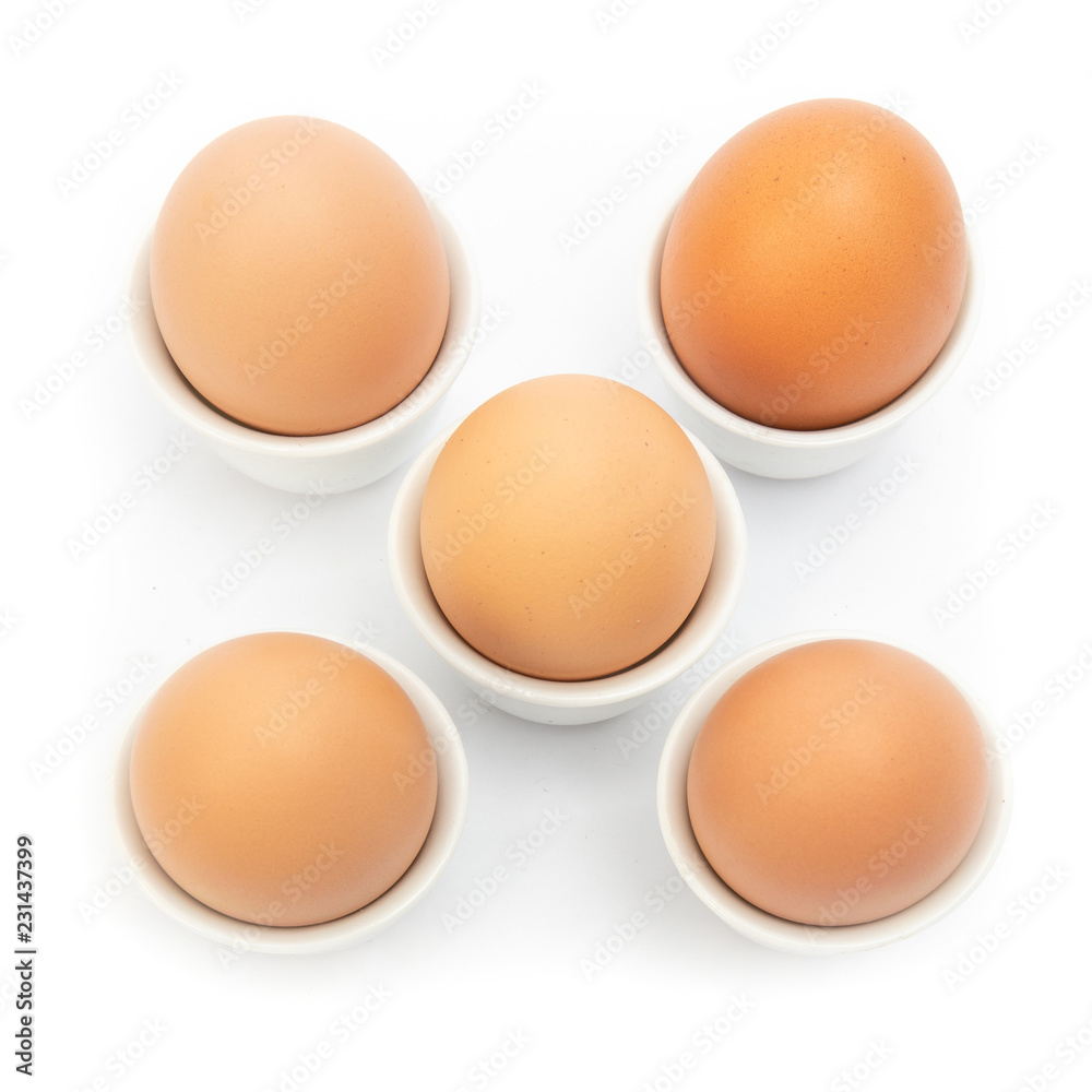 Brown Eggs in ceramic cup at White Background Brown Eggs in ceramic cup at White Background