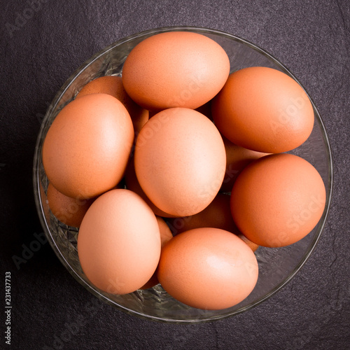Fresh farm eggs on black stone background,top view with copy space