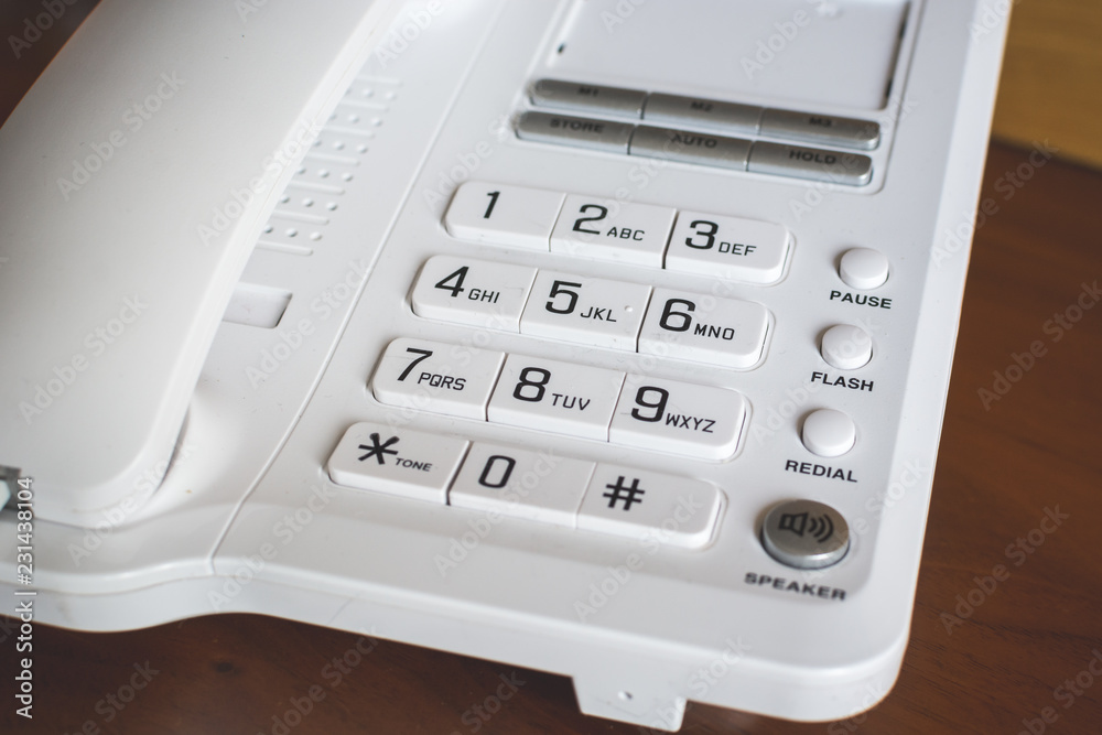 Office phone with large buttons on wooden table. Office phone with large buttons on wooden table.