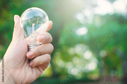 Female hand holding light bulb, Concept pure energy.