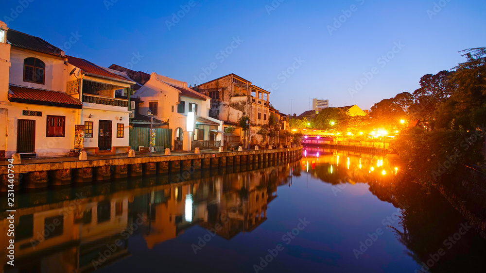 Mirror reflection od historical building in Malacca Riverside during blue hour before sunrise.