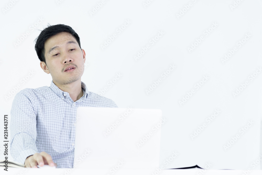 Asian employee salary man sitting at desk and working with lazy and sleepy, isolated on white background. Asian employee salary man sitting at desk and working with lazy and sleepy, isolated on white background.