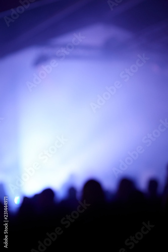 abstract photo, party, unrecognizable people, blue lights.