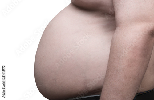 close up side view of overweight obese man and his big belly, isolated in white background. Poor nutrition and increased risk of heart disease. photo