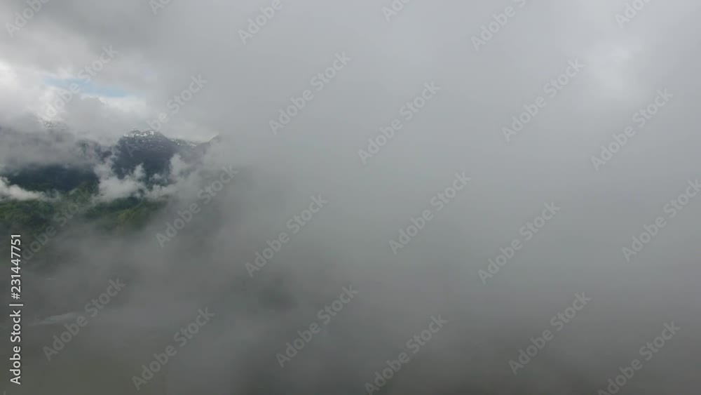 Flying through clouds over lake and mountains, 4k Flying through clouds over lake and mountains, 4k