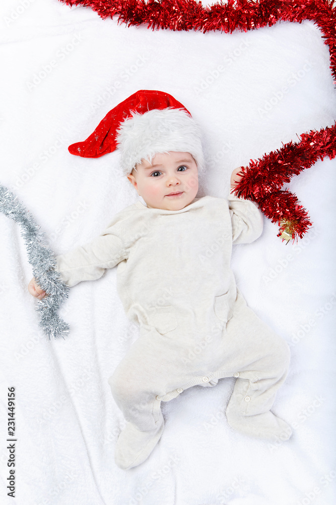 beautiful baby boy in christmas hat lying beautiful baby boy in christmas hat lying