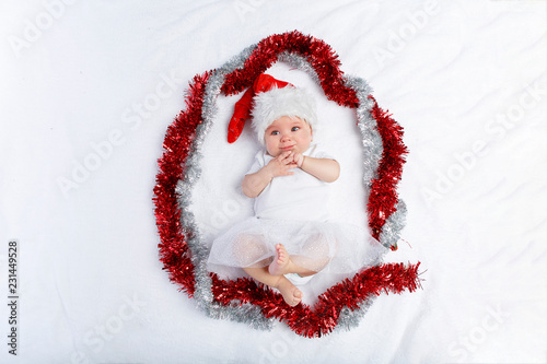 beautiful baby girl in christmas hat lying