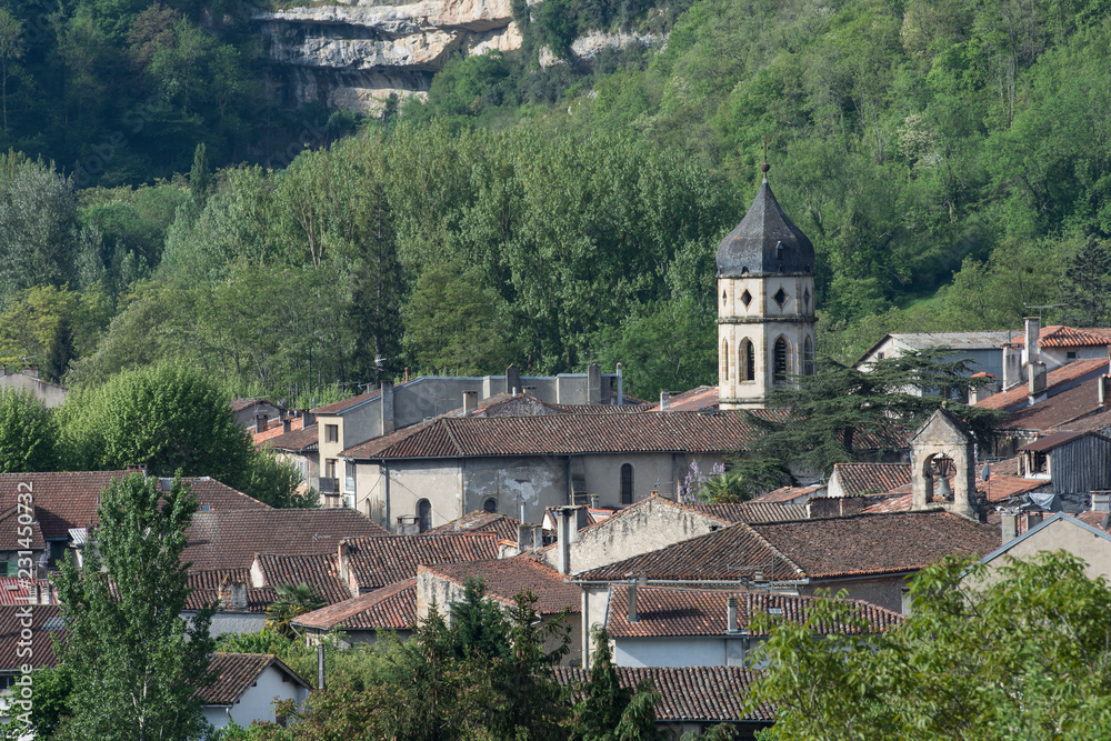 View over ancient rooftops in Ariege, France, with spire and forests in background