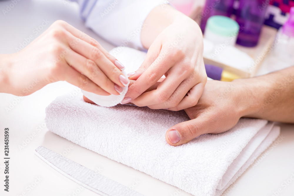 Hands during manicure care session Hands during manicure care session