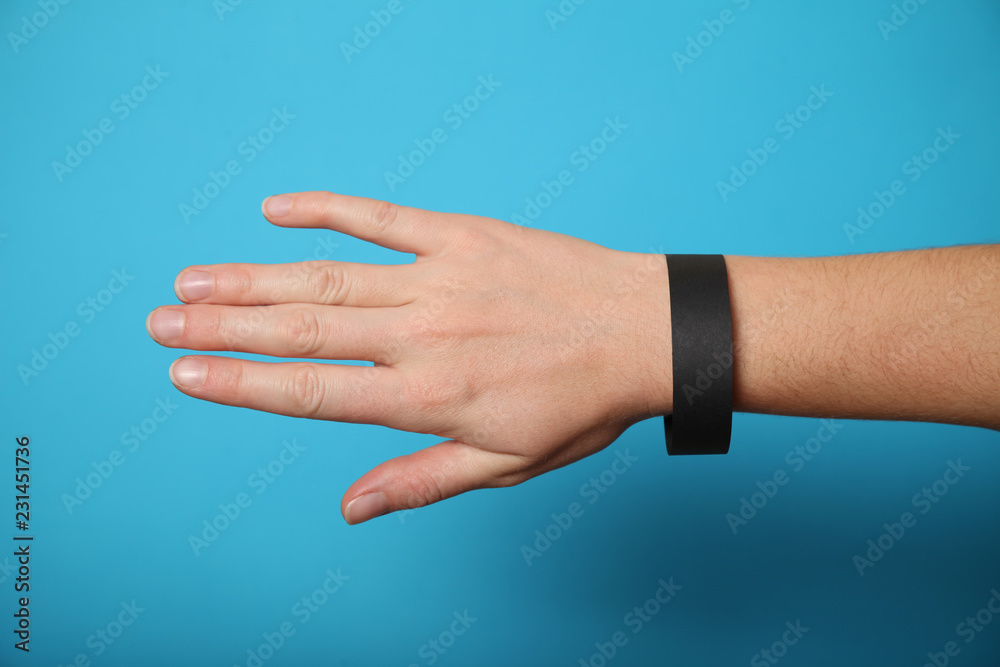 Black paper wristband mockup, event bracelet on hand. Empty ticket wrist band design.