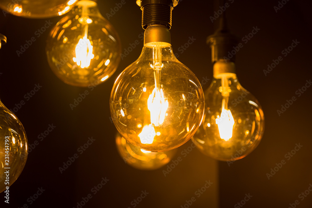 Cozy warm yellow light. Edison light bulb hanging. Closeup Cozy warm yellow light. Edison light bulb hanging. Closeup