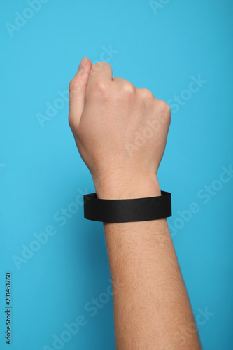 Black blank bracelet on hand. Music festival branding wristband, adhesive paper accessory for concert, event. mockup.