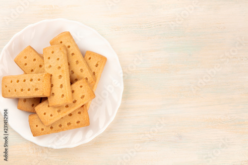 A photo of Scottish shortbread butter cookies, shot from above on a light background with copy space photo