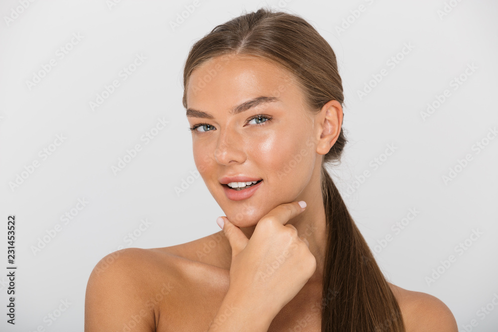 Beauty portrait of beautiful shirtless woman with long brown hair smiling at camera, isolated over white background Beauty portrait of beautiful shirtless woman with long brown hair smiling at camera, isolated over white background