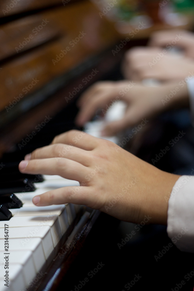 Children play piano in four hands