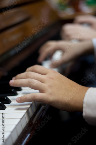 Children play piano in four hands