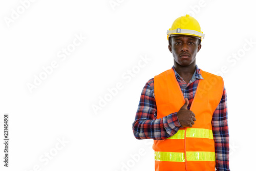 Studio shot of young black African man construction worker givin photo