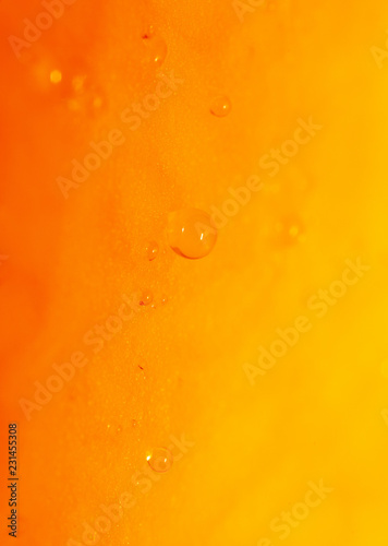 Drops of juice on pumpkin pulp as abstract background