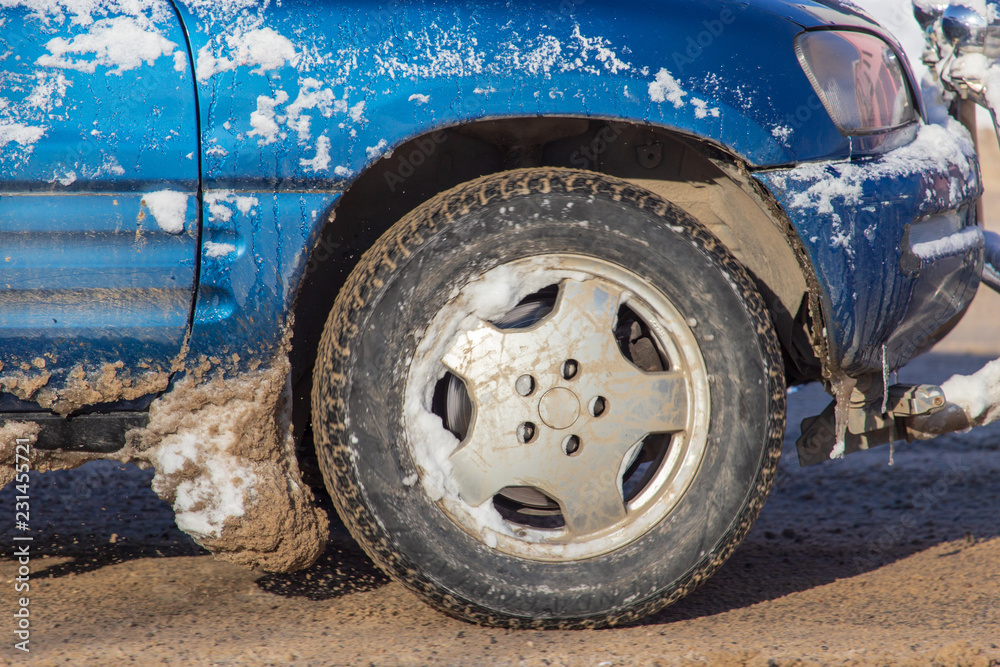 Car wheel in the snow in winter Car wheel in the snow in winter