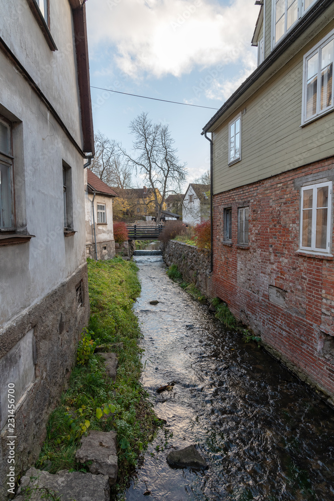 Small river between buildings in Kuldiga city, Latvia.