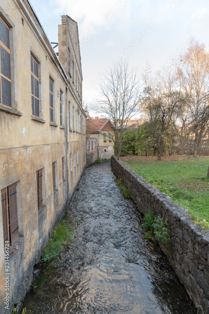 Small river between buildings in Kuldiga city, Latvia.