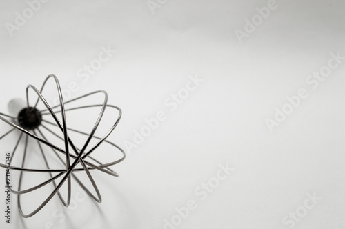 metal wire whisk on a white background close-up © Olga