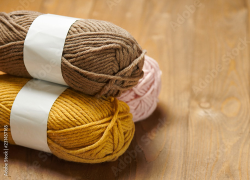 colorful wool yarn for knitting on wooden background