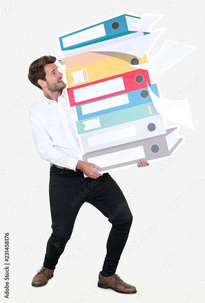 Young businessman carrying a stack of binders - obrazy, fototapety, plakaty 