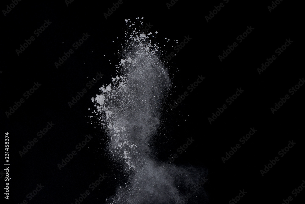 White powder explosion on black background. Dust splatted isolated. Paint Holi. White powder explosion on black background. Dust splatted isolated. Paint Holi.