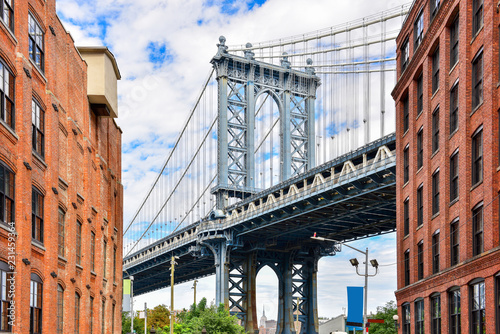 Fototapeta Naklejka Na Ścianę i Meble -  DUMBO district in Brooklyn. NEW YORK, USA. Dumbo is a neighborhood in the New York City borough of Brooklyn. Red buildings and Manhattan Bridge..
