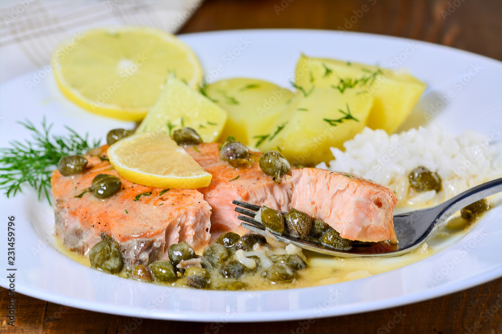Pan seared salmon with lemon garlic caper butter sauce. Salmon piccata with rice and boiled potatoes. Pan seared salmon with lemon garlic caper butter sauce. Salmon piccata with rice and boiled potatoes.