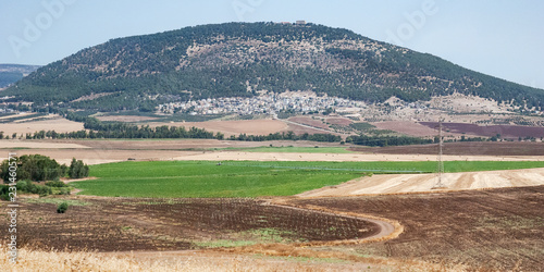 a panorama of mt tabor har tavor in the lower galilee in northern israel with modern agricultural fields in the foreground photo
