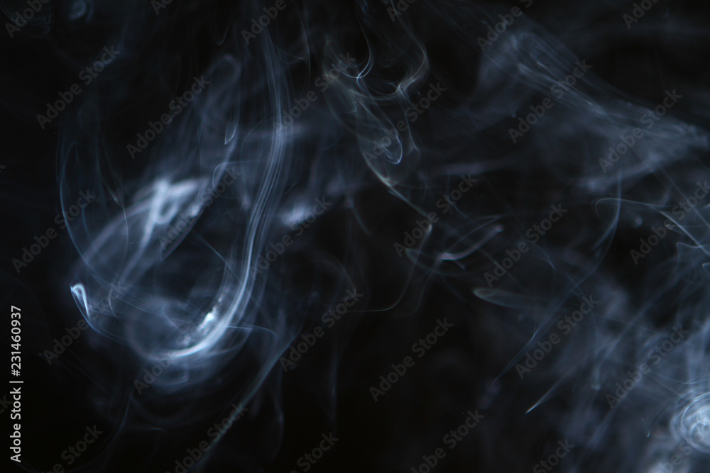 nice abstract light bright smoke on the heavy black background.