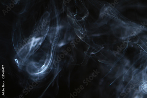 nice abstract light bright smoke on the heavy black background.
