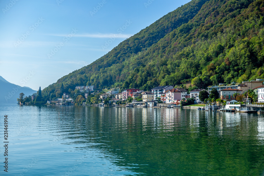 The view of the village of Melide on the shore of  the lake of Lugano on a warm sunny day in Autumn