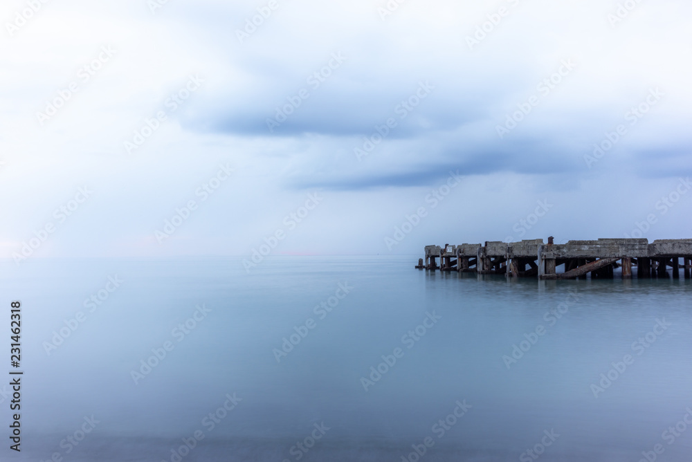 Obraz premium An abandoned pier on the Tuscan sea in Autumn at sunset with long exposure effect - 3