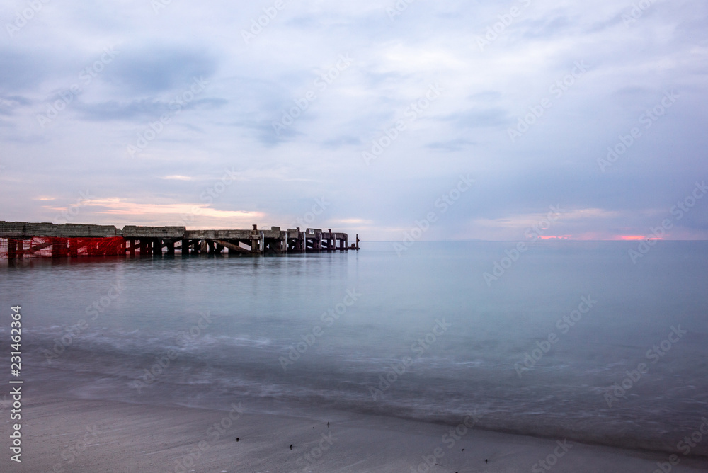 An abandoned pier on the Tuscan sea in Autumn at sunset with long exposure effect - 6