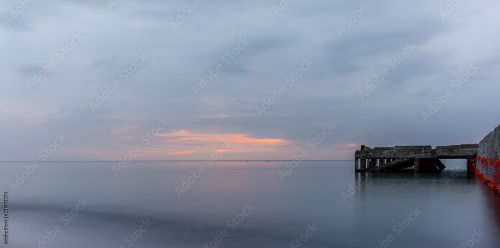 An abandoned pier on the Tuscan sea in Autumn at sunset with long exposure effect - 7