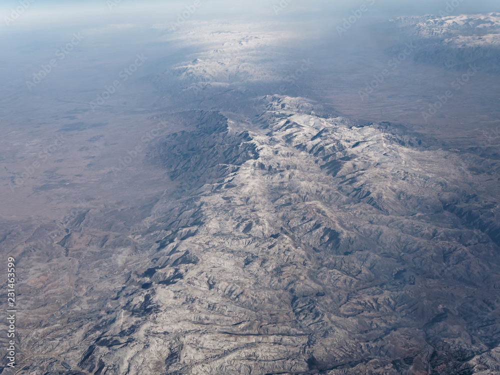 Fototapeta premium Aerial view of snow covered mountain ranges