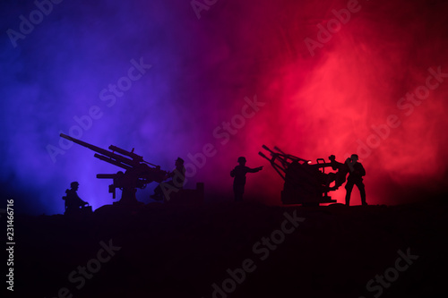 An anti-aircraft cannon and Military silhouettes fighting scene on war fog sky background, World War Soldiers Silhouettes Below Cloudy Skyline at sunset. Attack scene.