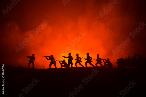 War Concept. Military silhouettes fighting scene on war fog sky background  World War German Tanks Silhouettes Below Cloudy Skyline At night. Attack scene. Armored vehicles.