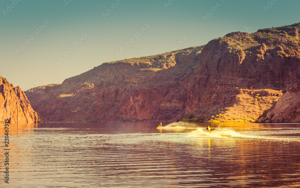 The red sheer cliffs surround Canyon Lake east of Phoenix, Arizona and a favorite water spot to boat, jet ski, hike explore the Arizona desert land with the cactus that grow near this man made lake