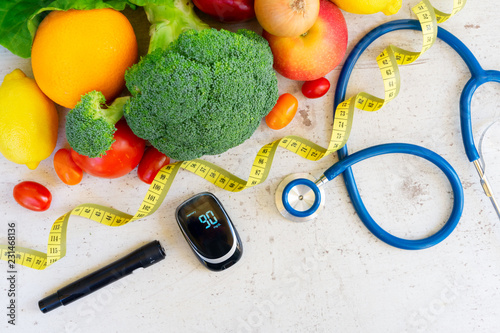 raw vegetables with blood glucose meter, lancet and stethoscope, , diabetes healthy diet concept photo