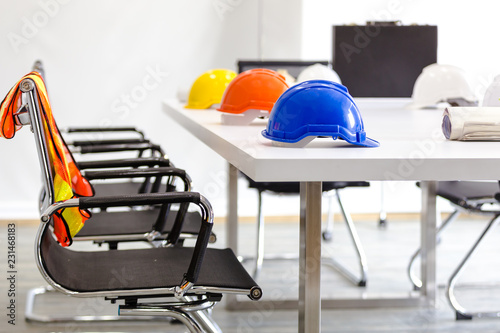 Safety helmet on table in office , engineer concept Teamwork of building construction