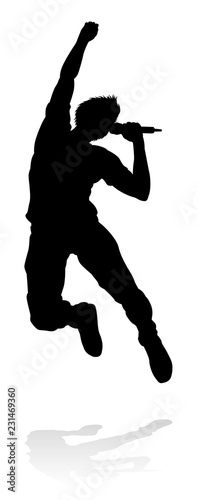 A singer pop, country music, rock star or hiphop rapper artist vocalist singing in silhouette