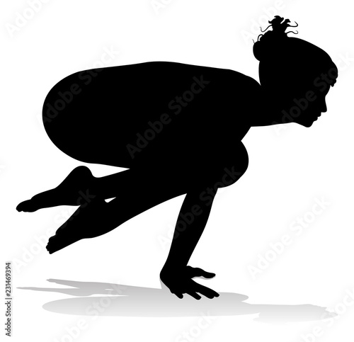 A silhouette of a woman in a yoga or pilates pose 