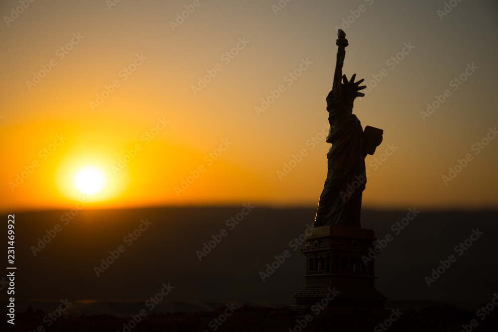 Statue of Liberty on the background of colorful dawn sky Statue of Liberty on the background of colorful dawn sky