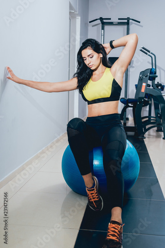 Young fitness woman with blue fitball. Crossfit training.